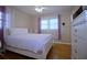 Comfortable bedroom featuring a white bed frame, hardwood floors, and ample natural light at 5235 Pounds S Dr, Stone Mountain, GA 30087