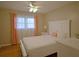 Bright bedroom featuring a white bed frame, a ceiling fan, and hardwood floors at 5235 Pounds S Dr, Stone Mountain, GA 30087
