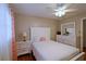 Cozy bedroom featuring white furniture, a ceiling fan, and warm-toned walls at 5235 Pounds S Dr, Stone Mountain, GA 30087