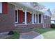 Classic brick home featuring a cozy covered front porch with columns and updated shutters at 5235 Pounds S Dr, Stone Mountain, GA 30087