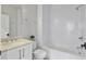Bathroom features a white vanity with carrara top and a shower over tub with white subway tiles at 574 Boulevard Ne Pl # 14, Atlanta, GA 30308