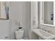 Stylish powder room featuring a sleek pedestal sink, modern fixtures, and elegant white finishes at 574 Boulevard Ne Pl # 14, Atlanta, GA 30308