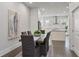 Modern dining room with a rustic wooden table and access to a sleek, modern kitchen at 574 Boulevard Ne Pl # 14, Atlanta, GA 30308