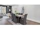 Stylish dining room with seating for six, modern art, dark wood floors, and bright natural light at 574 Boulevard Ne Pl # 14, Atlanta, GA 30308