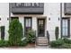 Close up of the entrance to the townhome, featuring manicured landscaping and detailed black trim at 574 Boulevard Ne Pl # 14, Atlanta, GA 30308