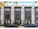 Modern townhome exterior showing the white painted brick, black window trim and lush landscaping at 574 Boulevard Ne Pl # 14, Atlanta, GA 30308