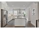 Open concept kitchen features modern appliances, gray countertops, and a center island at 574 Boulevard Ne Pl # 14, Atlanta, GA 30308