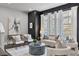 Cozy living room featuring large windows, a comfortable sofa, and stylish décor for a relaxing atmosphere at 574 Boulevard Ne Pl # 14, Atlanta, GA 30308