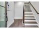Bright foyer showing the staircase with hardwood treads and a contemporary black handrail at 574 Boulevard Ne Pl # 14, Atlanta, GA 30308