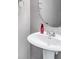 Powder room featuring a white pedestal sink, oval mirror, and neutral wall color at 6036 Oakley Rd, Union City, GA 30291