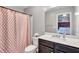 Bathroom features a patterned shower curtain, vanity with mirror and commode at 6036 Oakley Rd, Union City, GA 30291
