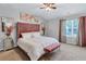 Bedroom featuring vaulted ceiling, decor art, a tufted headboard bed and carpet at 6036 Oakley Rd, Union City, GA 30291