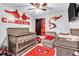 A cute bedroom with cool wall graphics, a crib and comfy chair at 6036 Oakley Rd, Union City, GA 30291