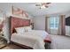Bedroom featuring vaulted ceiling, decor art, a tufted headboard bed and carpet at 6036 Oakley Rd, Union City, GA 30291