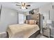 Bedroom features a tufted headboard bed, decorative mirror and unique bedside table at 6036 Oakley Rd, Union City, GA 30291