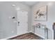 Bright entryway with hardwood flooring and a modern console table beneath floral art at 6036 Oakley Rd, Union City, GA 30291