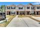 Inviting townhouse exterior featuring brick accents and a well-maintained lawn at 6036 Oakley Rd, Union City, GA 30291