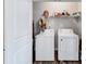 This laundry room features a side-by-side washer and dryer, and ample storage at 6036 Oakley Rd, Union City, GA 30291