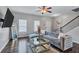 Modern living room with stylish decor, hardwood floors, and a ceiling fan at 6036 Oakley Rd, Union City, GA 30291