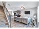 Open-concept living area with stairs, a plush couch, and a view of the kitchen at 6036 Oakley Rd, Union City, GA 30291