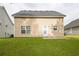 Exterior home back view with grassy lawn, siding and door, great for recreation at 150 Victoria Blvd, Oxford, GA 30054