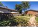 A shared backyard space with grassy area, walking path, and wooden fence under a blue sky at 2516 Bradford Ne Sq, Atlanta, GA 30345