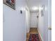 Bright hallway with wood floors, white walls adorned with art, and a view of the staircase, creating a clean and modern feel at 2516 Bradford Ne Sq, Atlanta, GA 30345
