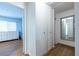 Bright hallway with closet space leading to a bedroom with hardwood floors and a window at 2516 Bradford Ne Sq, Atlanta, GA 30345