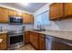 Modern kitchen with stainless steel appliances, granite countertops, and ample cabinet space for storage at 2516 Bradford Ne Sq, Atlanta, GA 30345