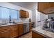 Functional kitchen with wood cabinets, granite countertops, and stainless steel appliances for cooking convenience at 2516 Bradford Ne Sq, Atlanta, GA 30345