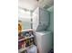 Efficient laundry area featuring a stacked washer and dryer and convenient shelving for storage of supplies at 2516 Bradford Ne Sq, Atlanta, GA 30345