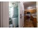 Convenient laundry area with a stacked washer and dryer, next to a storage and a sliding barn door at 2516 Bradford Ne Sq, Atlanta, GA 30345