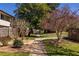 A shared walkway to the units with trees and bushes creating curb appeal at 2516 Bradford Ne Sq, Atlanta, GA 30345