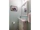 Half-bathroom featuring light blue walls, modern sink, mirror, towel rack, and artwork at 2516 Bradford Ne Sq, Atlanta, GA 30345