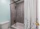 Shower and tub combo featuring neutral gray tiles at 2516 Bradford Ne Sq, Atlanta, GA 30345