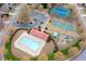 Aerial view of community amenities includes pool, tennis courts, basketball court, playground, and clubhouse at 65 Turtle Rock Cv, Acworth, GA 30101