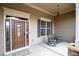 Covered front porch featuring a decorative pendant light, rocking chairs, and sidelight windows at 65 Turtle Rock Cv, Acworth, GA 30101