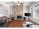 A spacious living room featuring a stone fireplace and lots of natural light at 65 Turtle Rock Cv, Acworth, GA 30101