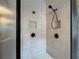 Modern bathroom shower with light tiled walls, dual shower heads, and built-in shelving niches at 65 Turtle Rock Cv, Acworth, GA 30101