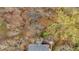 Aerial view of a home with a wooded backyard featuring a covered pavilion and fire pit at 931 Cornwall Sw Ct, Marietta, GA 30064
