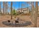 Wooded backyard with a mulched fire pit area and view of the home at 931 Cornwall Sw Ct, Marietta, GA 30064