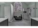 Modern primary bathroom showcases a standalone tub, glass-enclosed shower, and a large window at 931 Cornwall Sw Ct, Marietta, GA 30064