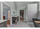 This bathroom features a modern vanity, walk-in closet, and stunning freestanding tub at 931 Cornwall Sw Ct, Marietta, GA 30064