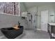 This bathroom features a freestanding tub, a glass walk-in shower, and a large window at 931 Cornwall Sw Ct, Marietta, GA 30064