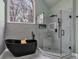 This bathroom features a walk-in shower, free standing tub, and modern vanity at 931 Cornwall Sw Ct, Marietta, GA 30064