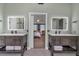 This bathroom features dual vanities with backlit mirrors and access to the main bedroom at 931 Cornwall Sw Ct, Marietta, GA 30064