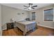 Cozy bedroom featuring hardwood floors, neutral walls, ceiling fan, and two windows with wooden blinds at 931 Cornwall Sw Ct, Marietta, GA 30064