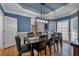 Elegant dining room with hardwood floors, tray ceiling, and modern lighting fixture at 931 Cornwall Sw Ct, Marietta, GA 30064