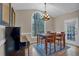 Dining room boasts a large window, hardwood floors, piano and a modern chandelier at 931 Cornwall Sw Ct, Marietta, GA 30064
