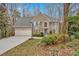 Charming home featuring a two-car garage, well-maintained landscaping, and beautiful architectural details at 931 Cornwall Sw Ct, Marietta, GA 30064